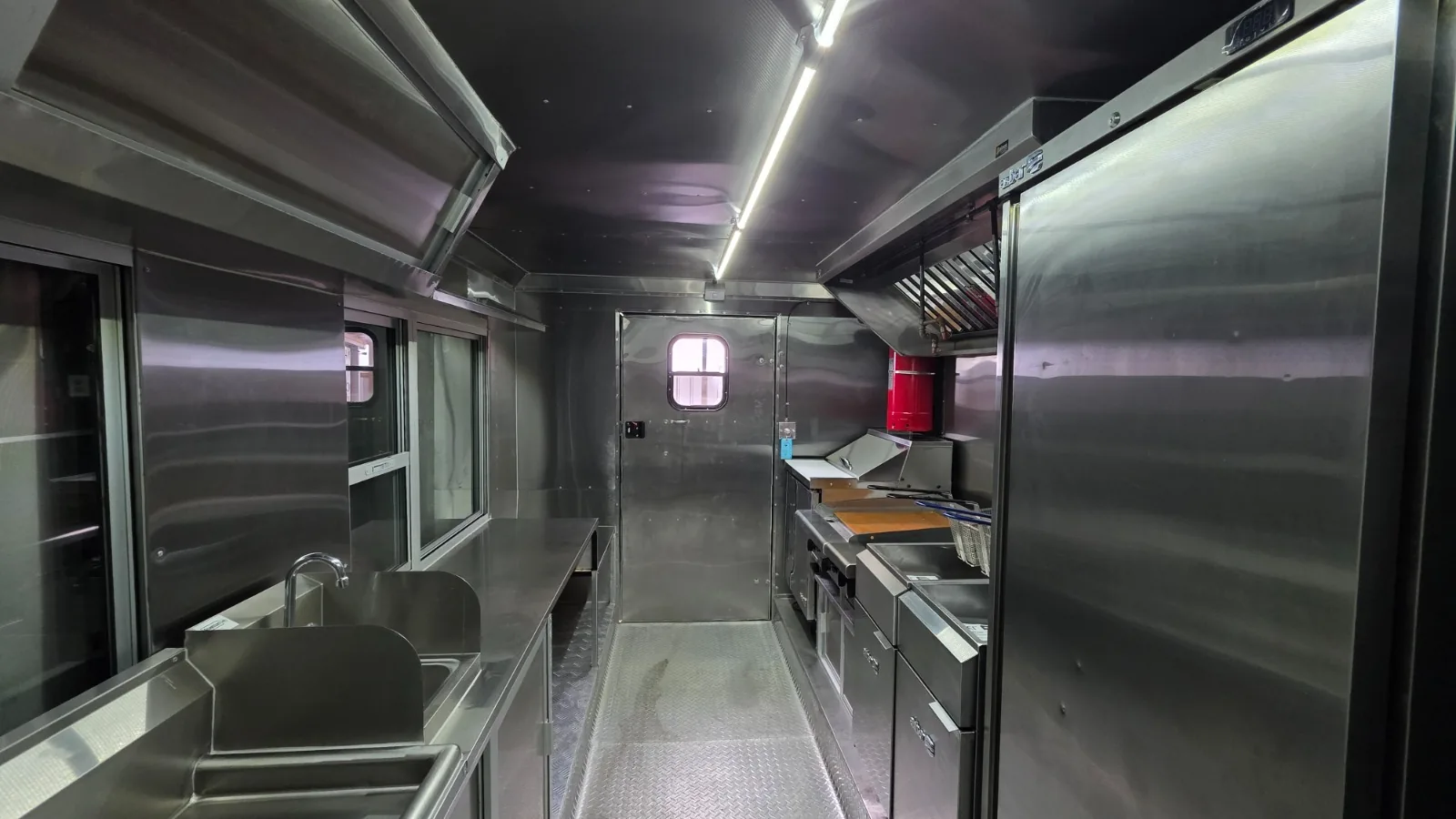 Carranza mobile kitchen interior with stainless-steel sink, cook line and refrigerator