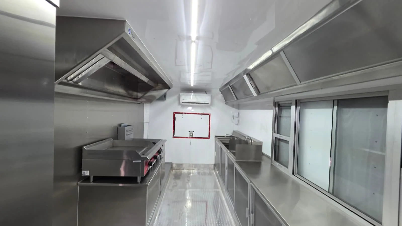 Bright Carranza mobile kitchen interior with stainless-steel counters and ventilation